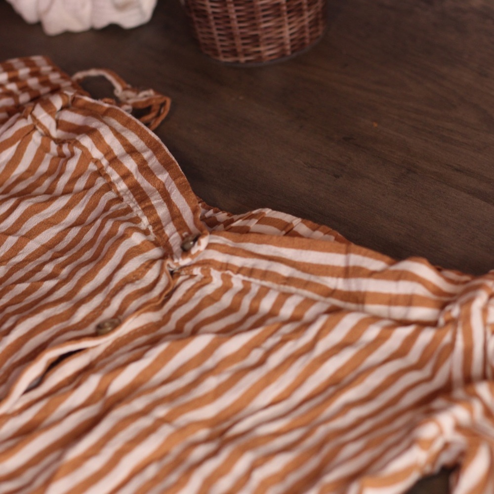 Cute and chic colorful striped blouse. Button up on front. With spaghetti straps